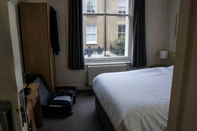 Double bed and sash window in a simple budget hotel room