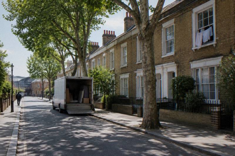 Sunny King's Cross residential street with yellow brick terraces, plane trees and chimney pots