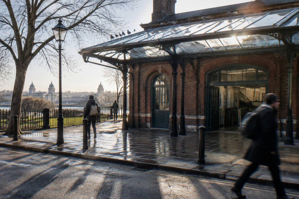 A London overground station exterior with a glass and brick facade and no readable signage