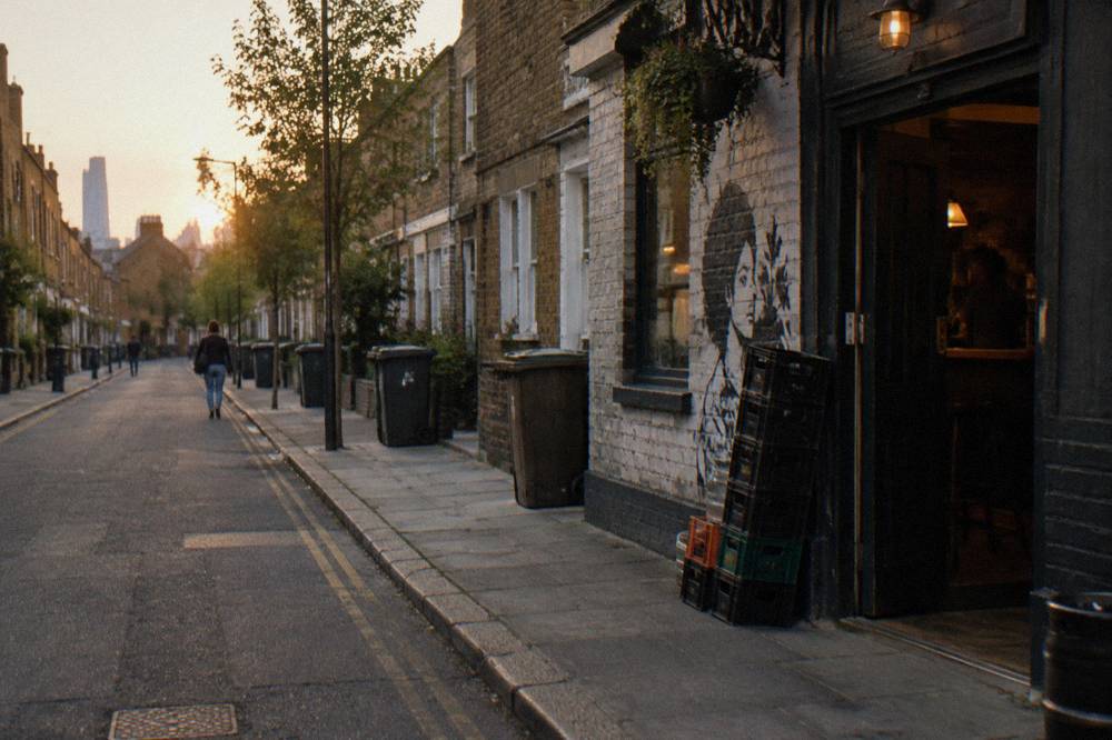 A narrow London street with terraced brick houses and parked bicycles