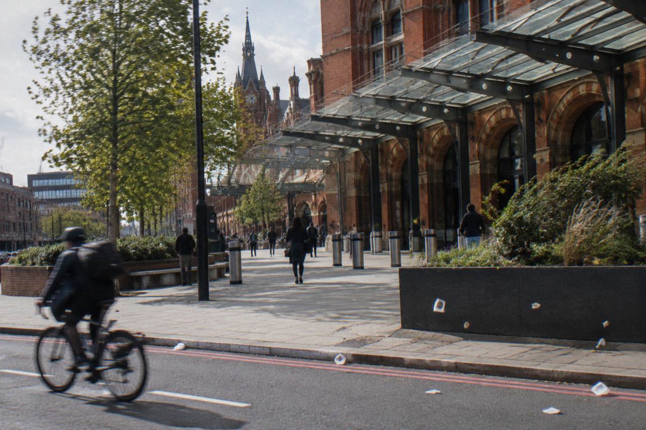 A London street with a station exterior and red brick buildings in the background