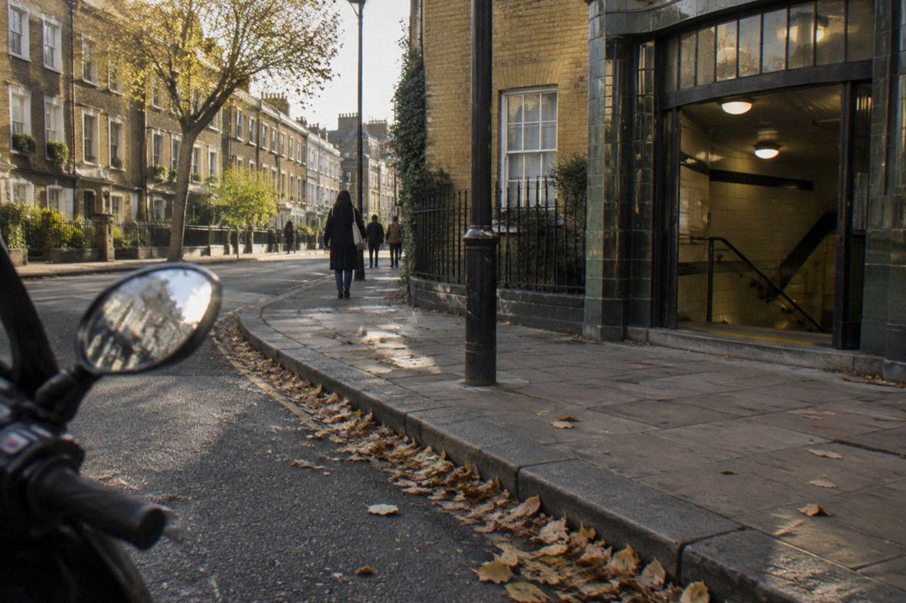 A London street of tall terraced houses with a underground station entrance at the corner
