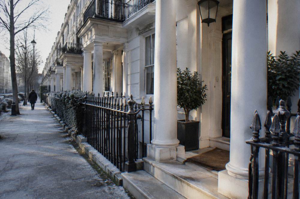 A classic London hotel facade of white stucco with columned entrance