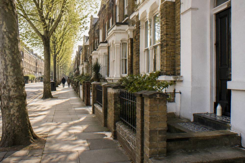 A Victorian terrace street in East London with plane trees along the pavement