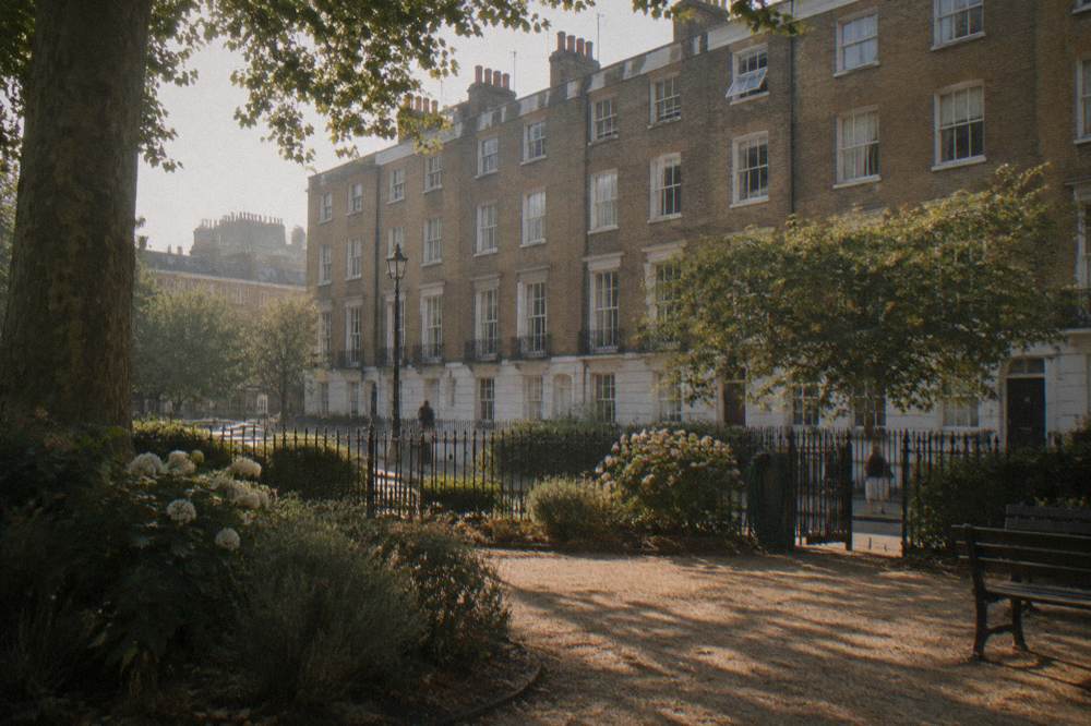 A London street of five storey brick terraces near a garden square