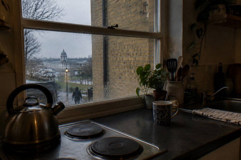 A studio kitchenette with a small counter, two hobs and a kettle