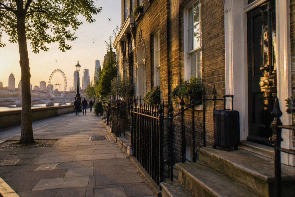 A London terraced street with budget hotel entrances and warm evening light