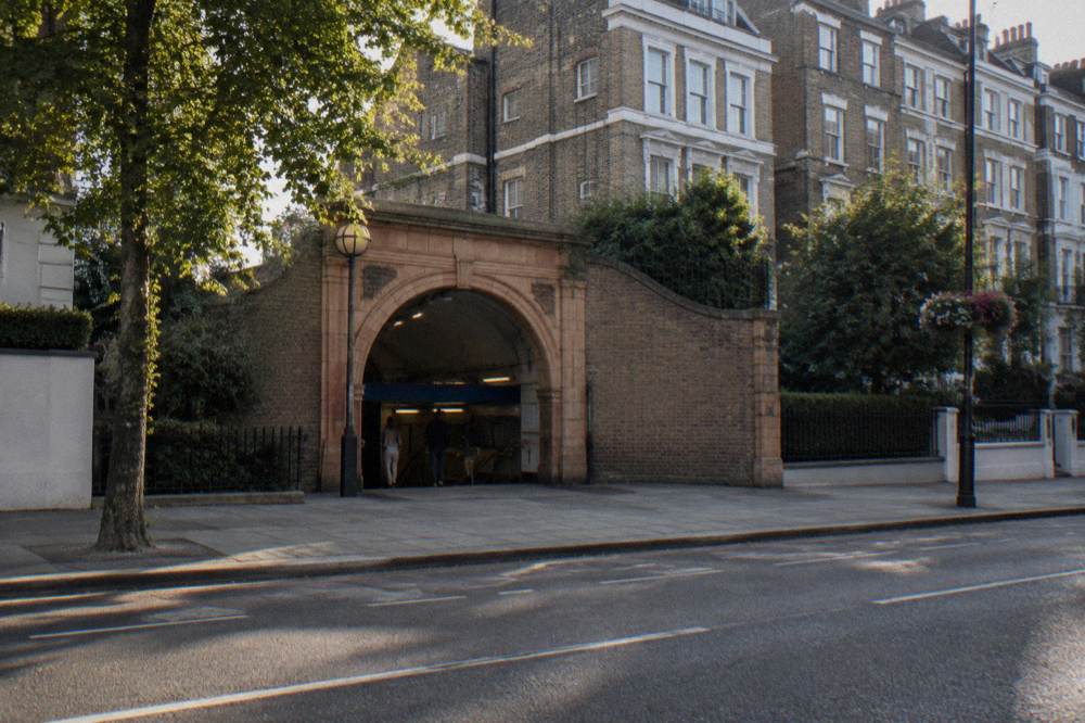 A station entrance on a west London street with terraced housing behind it