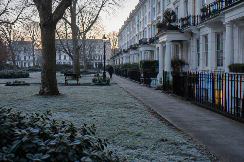 Rows of white terraced houses with columned porches in a west London square