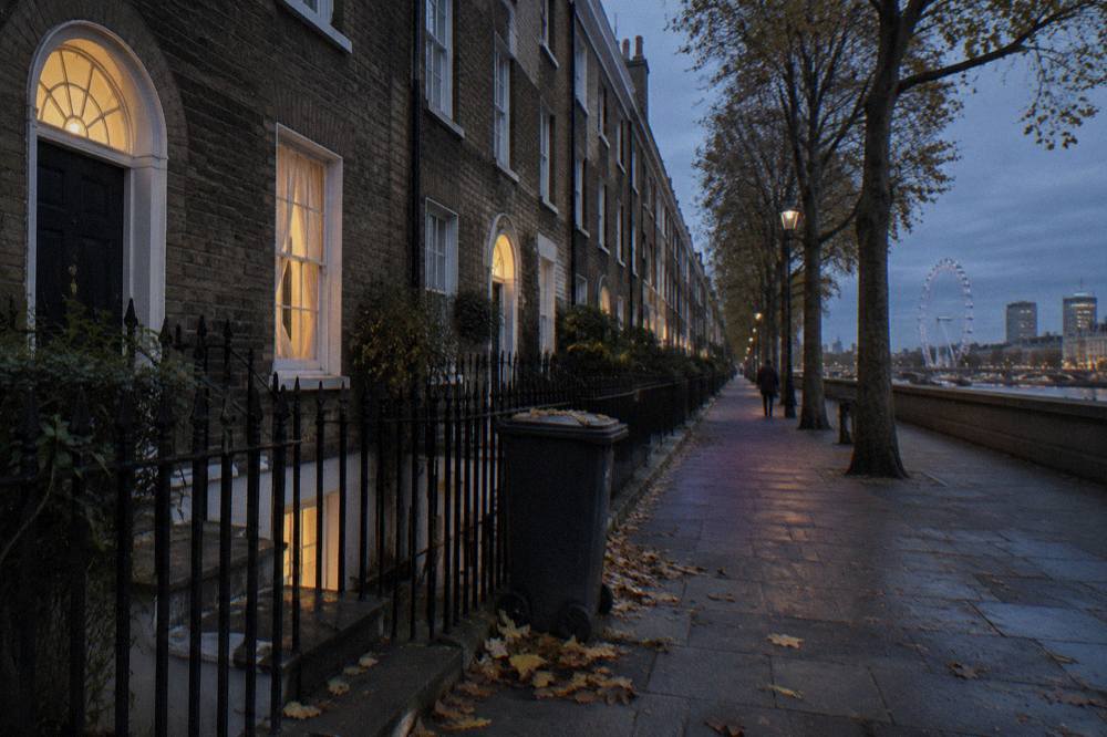 A row of London terrace houses on a residential street at dusk