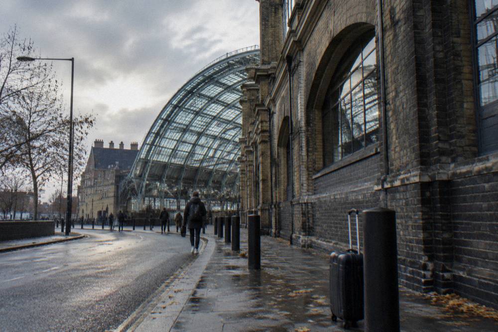 A London station exterior with a glass and brick facade
