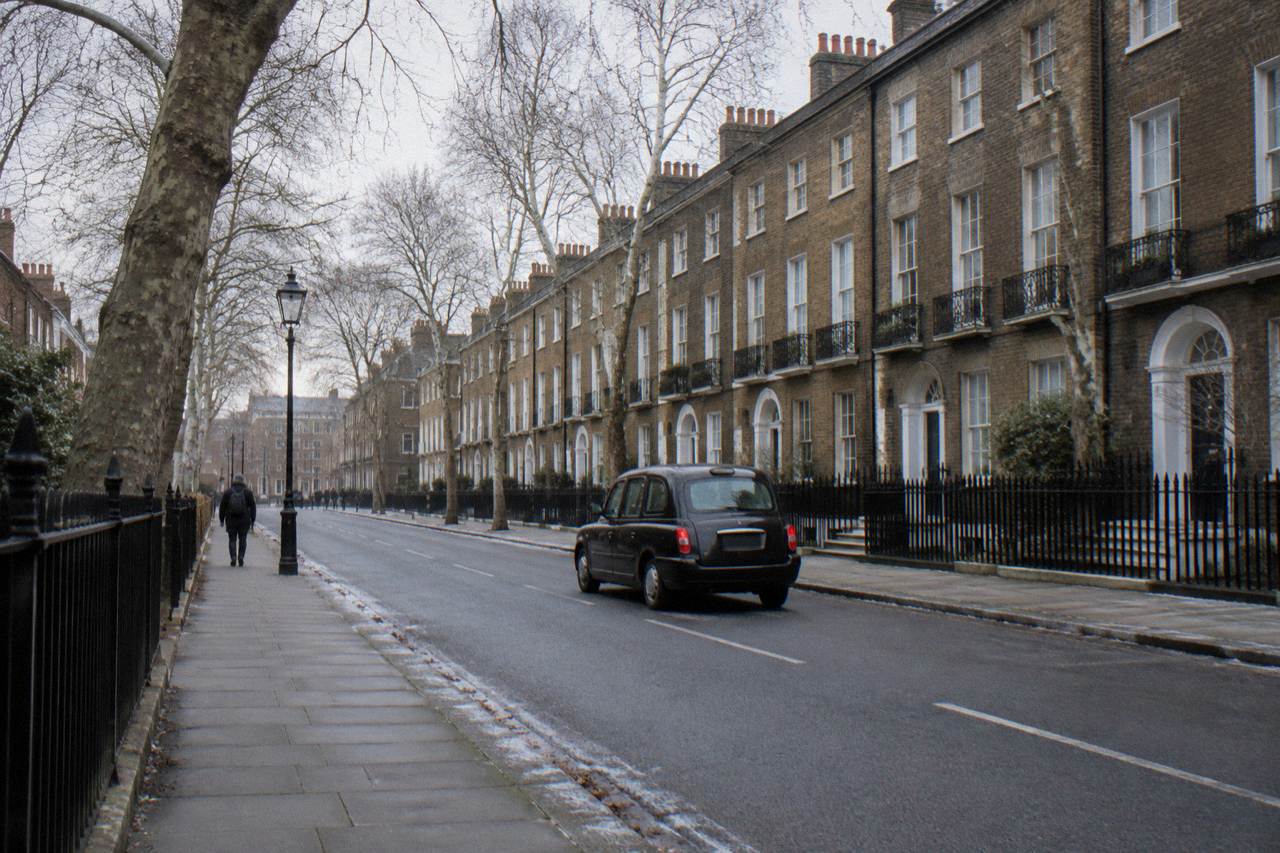 A quiet London street of brick townhouses under a pale winter sky
