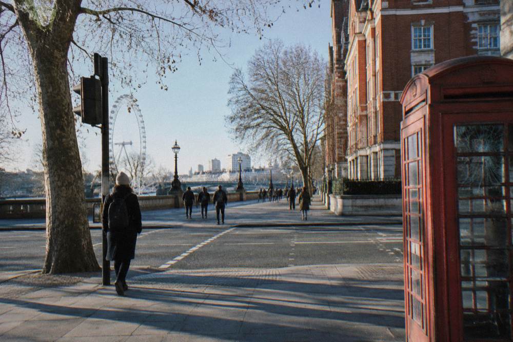 A London street corner with a brick building and a pedestrian crossing